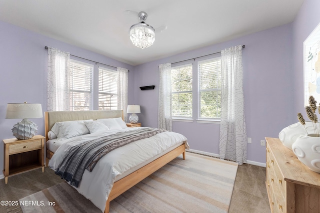 bedroom featuring dark carpet and a notable chandelier