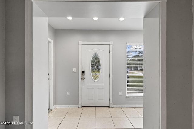 foyer entrance with light tile patterned flooring