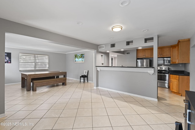 kitchen featuring light tile patterned floors and appliances with stainless steel finishes