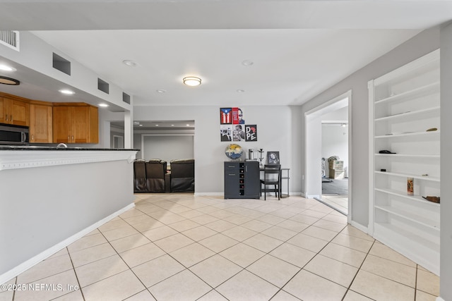 interior space with light tile patterned floors and built in features