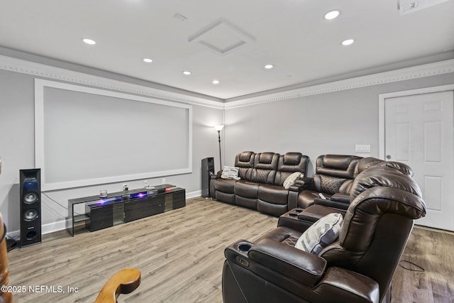 home theater room featuring ornamental molding and light hardwood / wood-style flooring