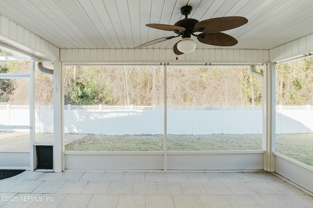 unfurnished sunroom featuring ceiling fan