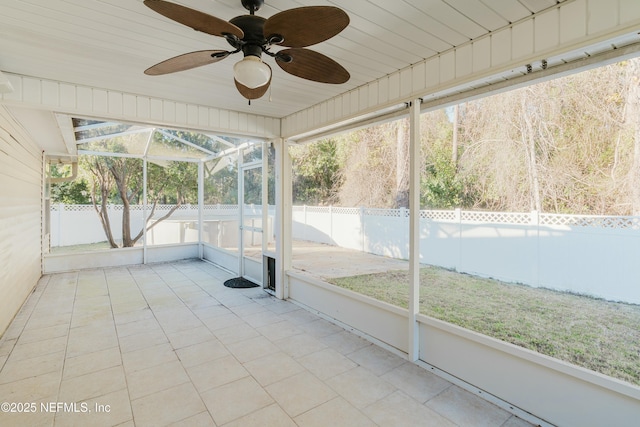 unfurnished sunroom with ceiling fan