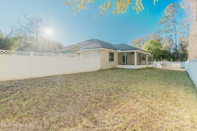 rear view of property featuring a lawn