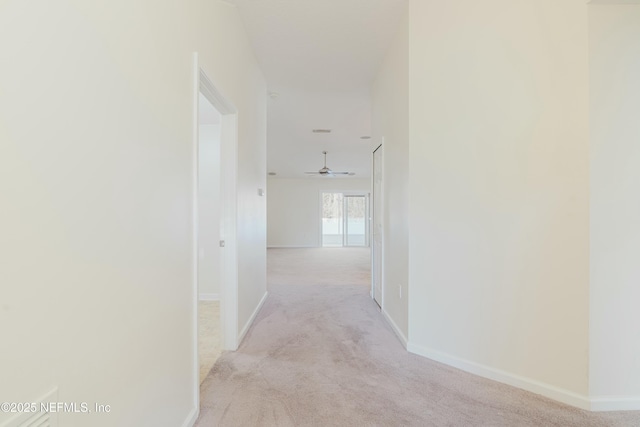 hallway featuring light carpet