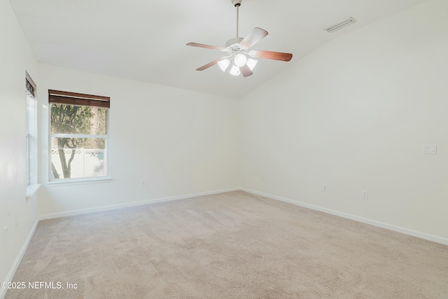 empty room featuring ceiling fan, light carpet, and lofted ceiling