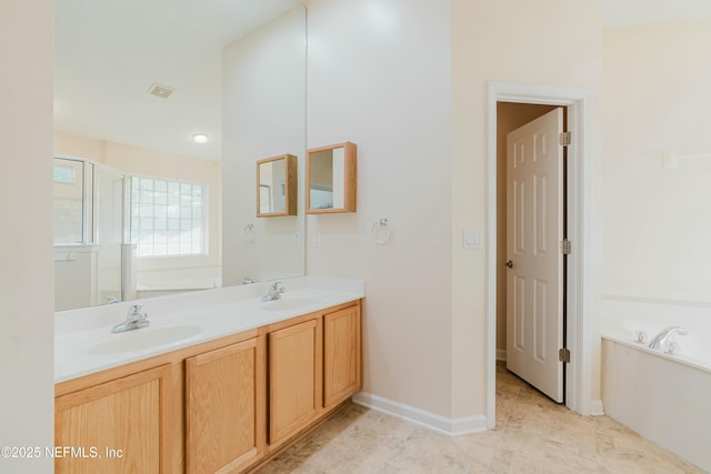 bathroom with vanity and shower with separate bathtub