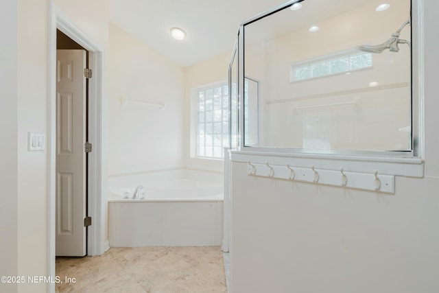 bathroom featuring independent shower and bath