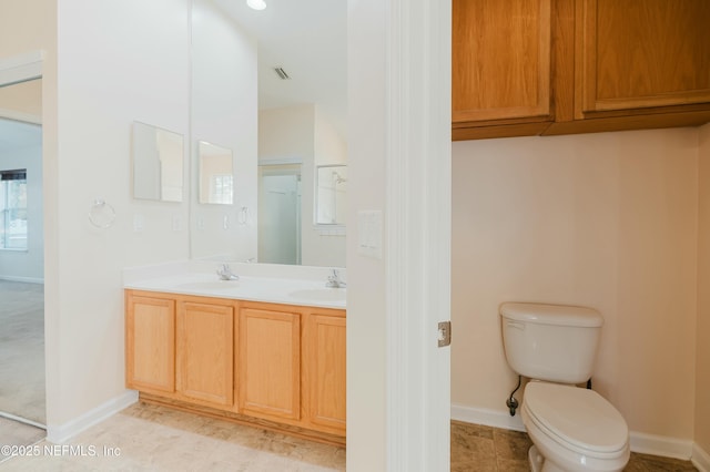 bathroom with toilet and vanity