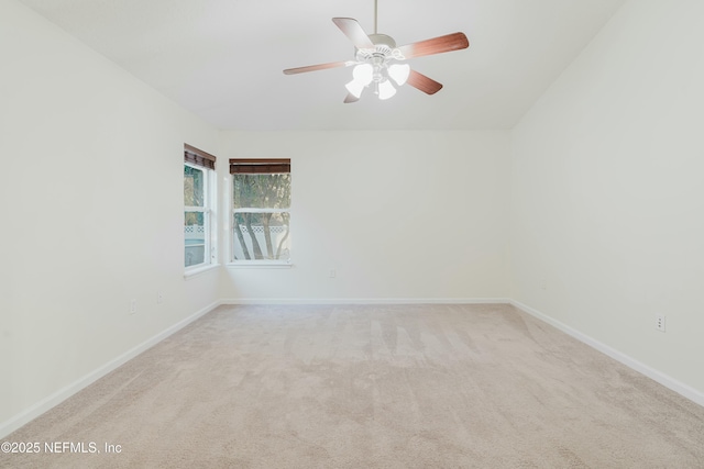 unfurnished room featuring ceiling fan and light colored carpet