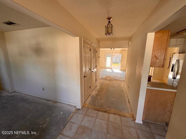 hallway featuring a textured ceiling