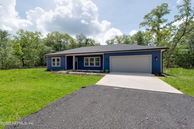 ranch-style home featuring a front lawn and a garage