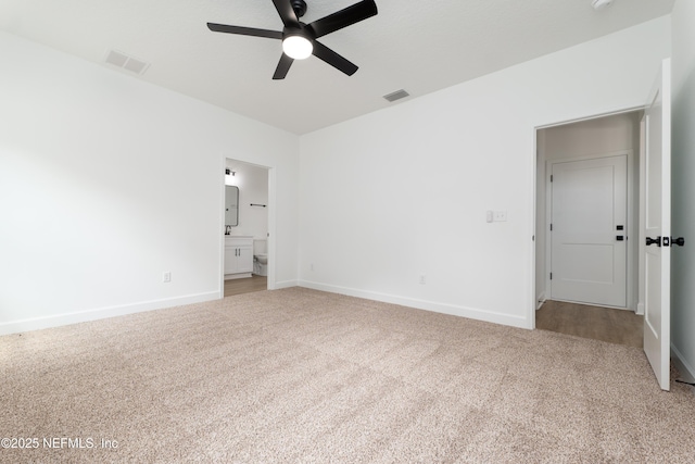 unfurnished bedroom featuring ceiling fan, carpet, and ensuite bath