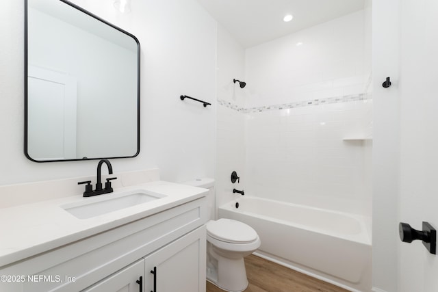 full bathroom with wood-type flooring, toilet, vanity, and bathing tub / shower combination