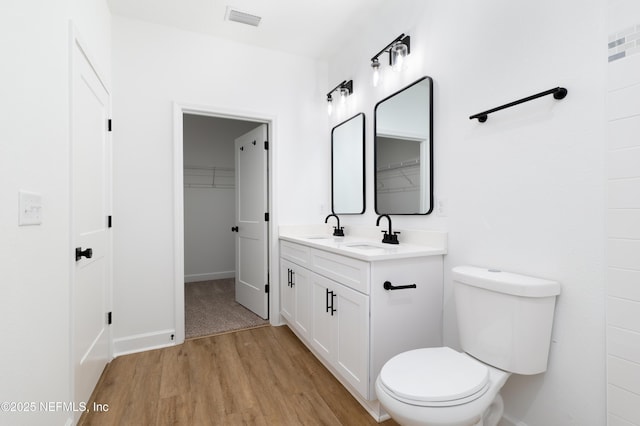 bathroom with vanity, hardwood / wood-style flooring, and toilet