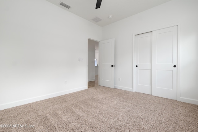 unfurnished bedroom with a closet, ceiling fan, and carpet floors