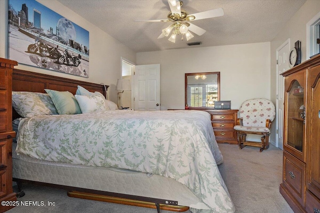 bedroom with light carpet, a textured ceiling, and ceiling fan