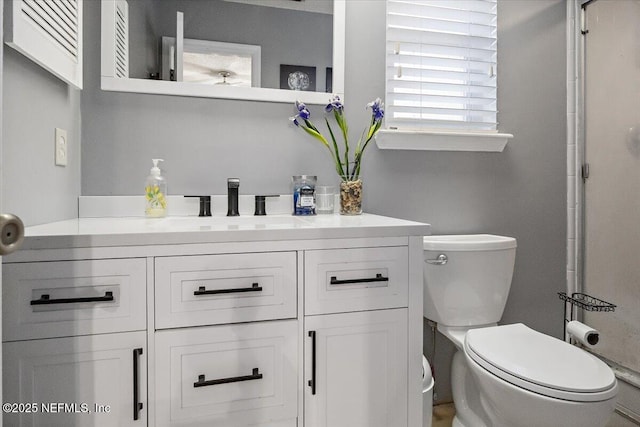 bathroom featuring vanity and toilet