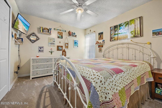 bedroom featuring ceiling fan, a textured ceiling, and carpet floors