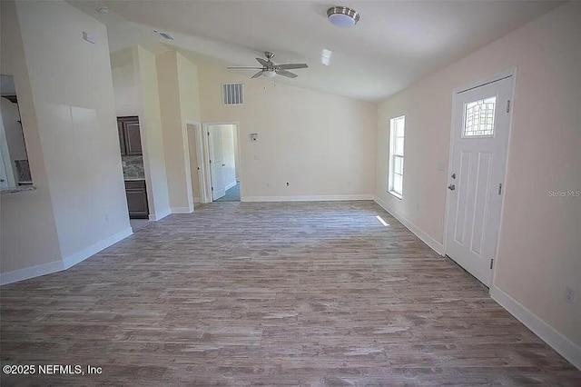 foyer entrance with ceiling fan, high vaulted ceiling, and wood-type flooring