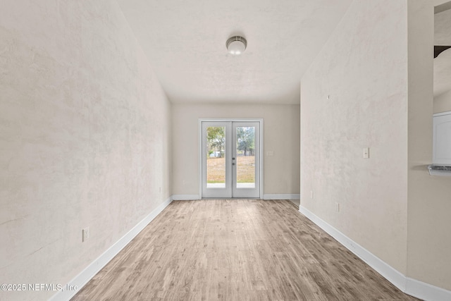 unfurnished room featuring hardwood / wood-style floors and french doors