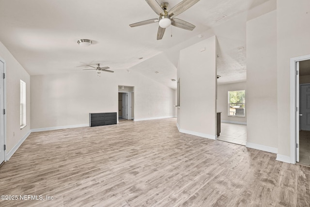 unfurnished living room featuring lofted ceiling, light hardwood / wood-style flooring, and ceiling fan