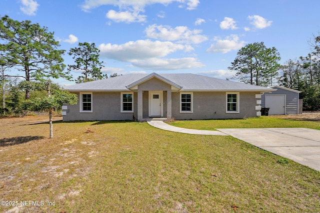 ranch-style home featuring a garage, an outdoor structure, and a front lawn