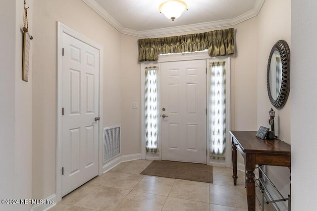 tiled entrance foyer featuring crown molding