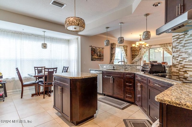 kitchen with a kitchen island, pendant lighting, decorative backsplash, and dishwasher