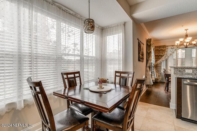 dining room with a notable chandelier, crown molding, and light tile patterned floors