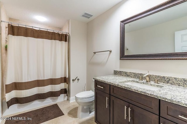 bathroom featuring toilet, tile patterned flooring, walk in shower, and vanity