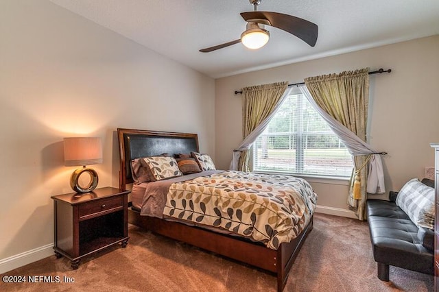 bedroom featuring ceiling fan and dark colored carpet