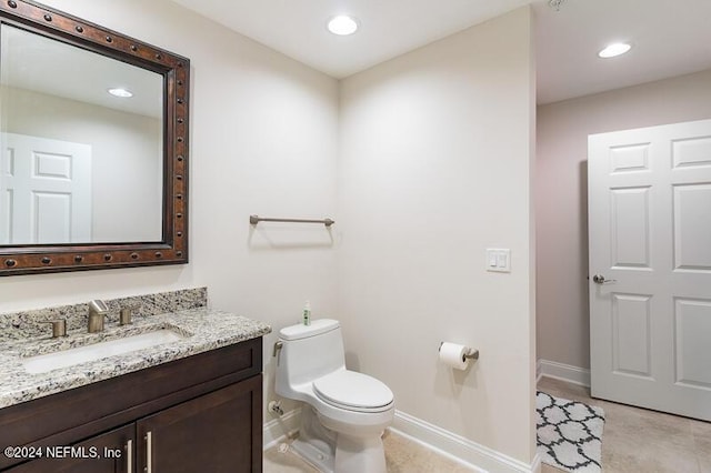 bathroom featuring toilet and vanity