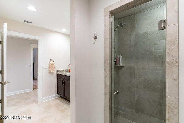 bathroom featuring vanity and a shower with door