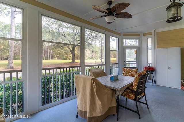 sunroom / solarium featuring ceiling fan