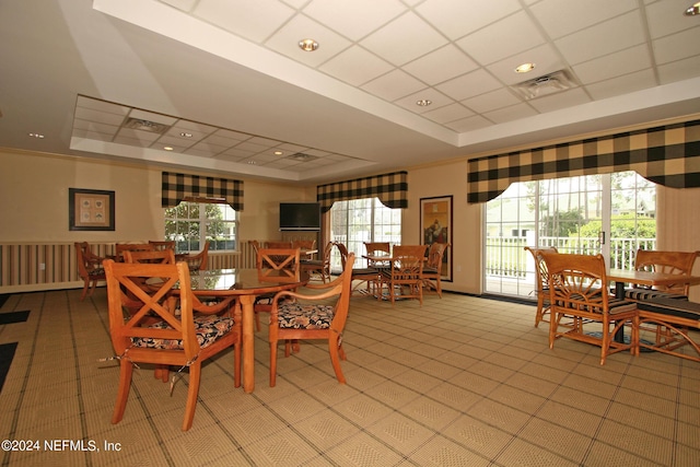 dining space with a drop ceiling and a tray ceiling