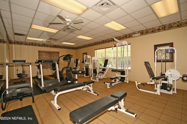 workout area featuring a paneled ceiling and ceiling fan