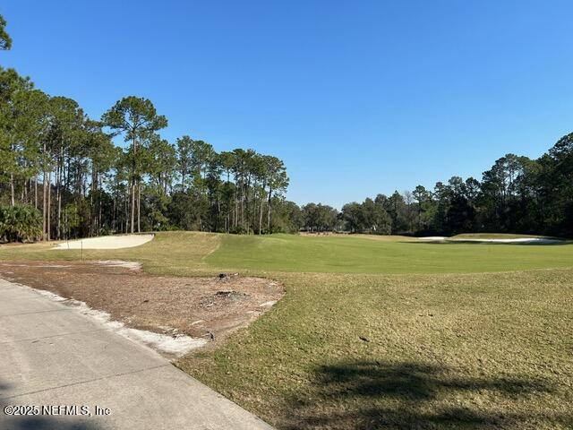 view of home's community featuring a lawn