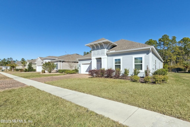 view of front of house with a front yard and a garage