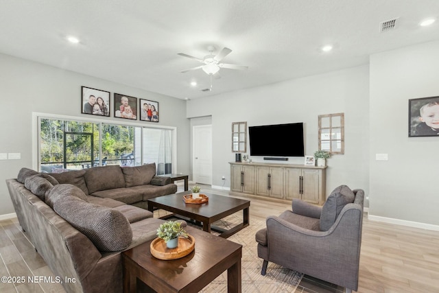 living room with light wood-type flooring and ceiling fan