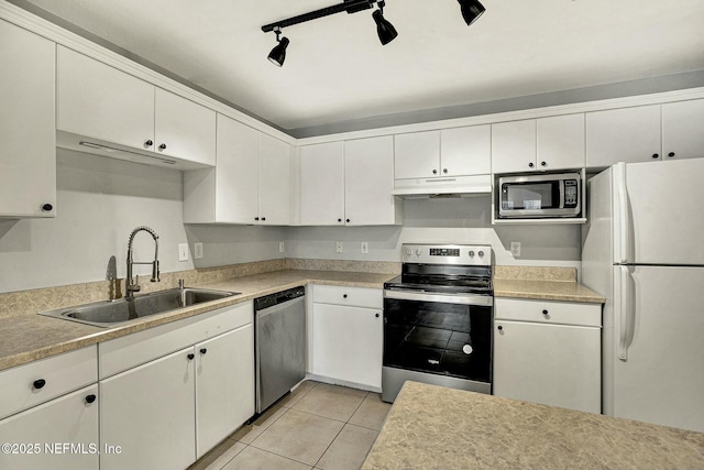 kitchen with white cabinets, appliances with stainless steel finishes, rail lighting, and sink