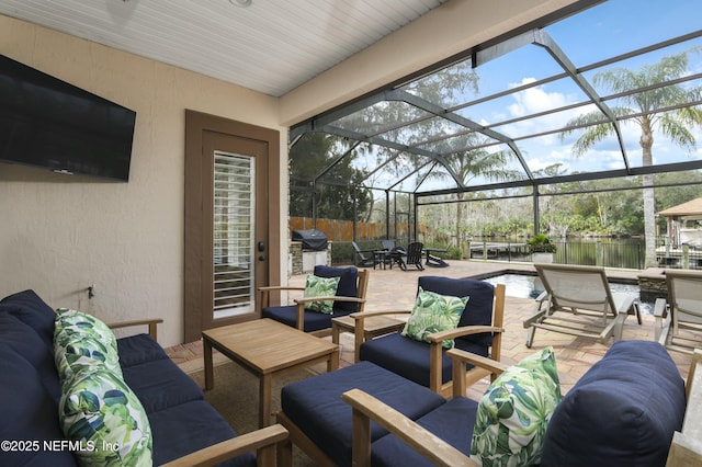 view of patio / terrace with glass enclosure and an outdoor living space