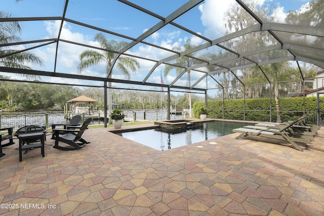 view of swimming pool with a water view, glass enclosure, an in ground hot tub, and a patio area