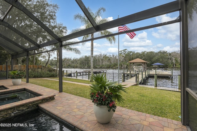 view of patio featuring a water view, an in ground hot tub, and a gazebo