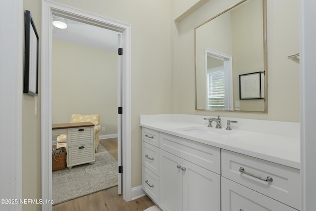 bathroom with vanity and hardwood / wood-style flooring