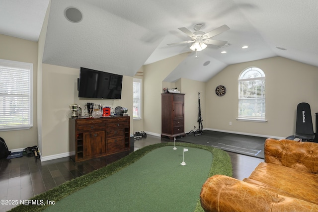 interior space with a textured ceiling, ceiling fan, vaulted ceiling, and dark hardwood / wood-style floors