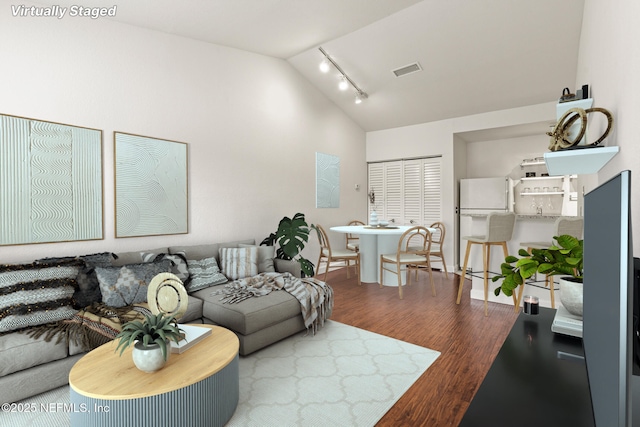 living room featuring hardwood / wood-style flooring and vaulted ceiling