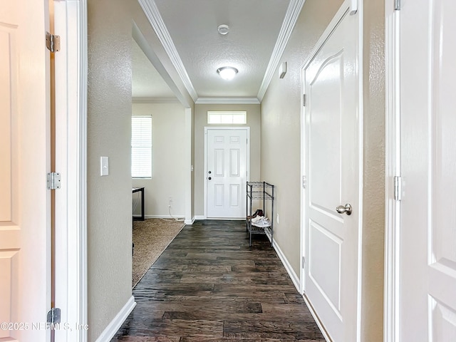 foyer entrance with a textured ceiling, ornamental molding, and dark hardwood / wood-style flooring