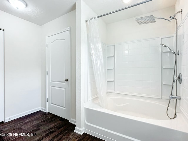 bathroom featuring hardwood / wood-style floors, a textured ceiling, and shower / bath combo