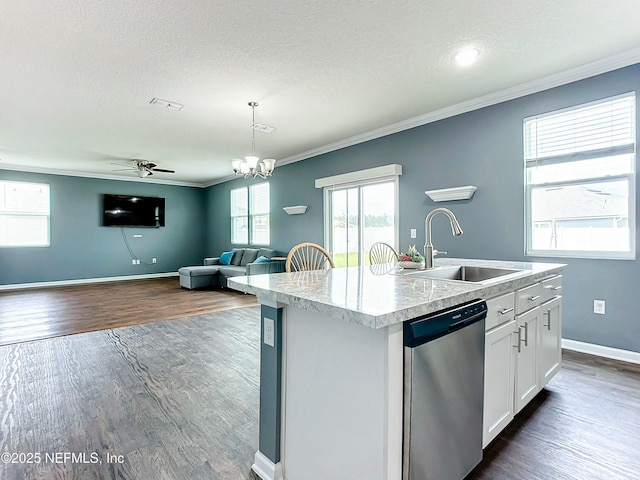 kitchen with an island with sink, dishwasher, pendant lighting, white cabinets, and sink